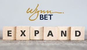 WynnBet Logo Over the Word Expand Written with Scrabble Letters