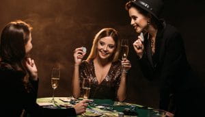 Three Women Playing Poker and Drinking Champagne