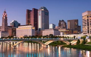 A Picture of Ohio Buildings by a River 