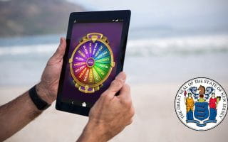 Wheel of Fortune on a Tablet next to the New Jersey Logo