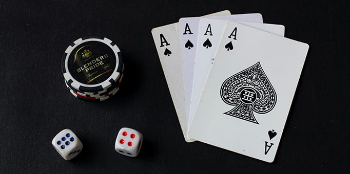 Cards, Dice, and Poker Chips on Black Surface